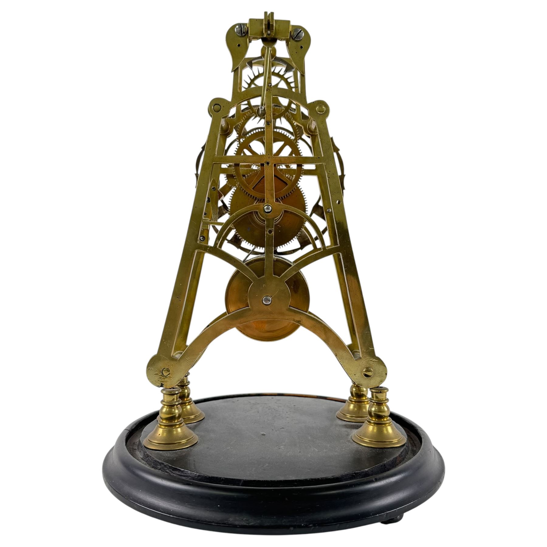 Brass skeleton clock, the single fusee movement with silvered Roman numeral dial, upon an ebonised circular base, missing the glass dome, H32cm