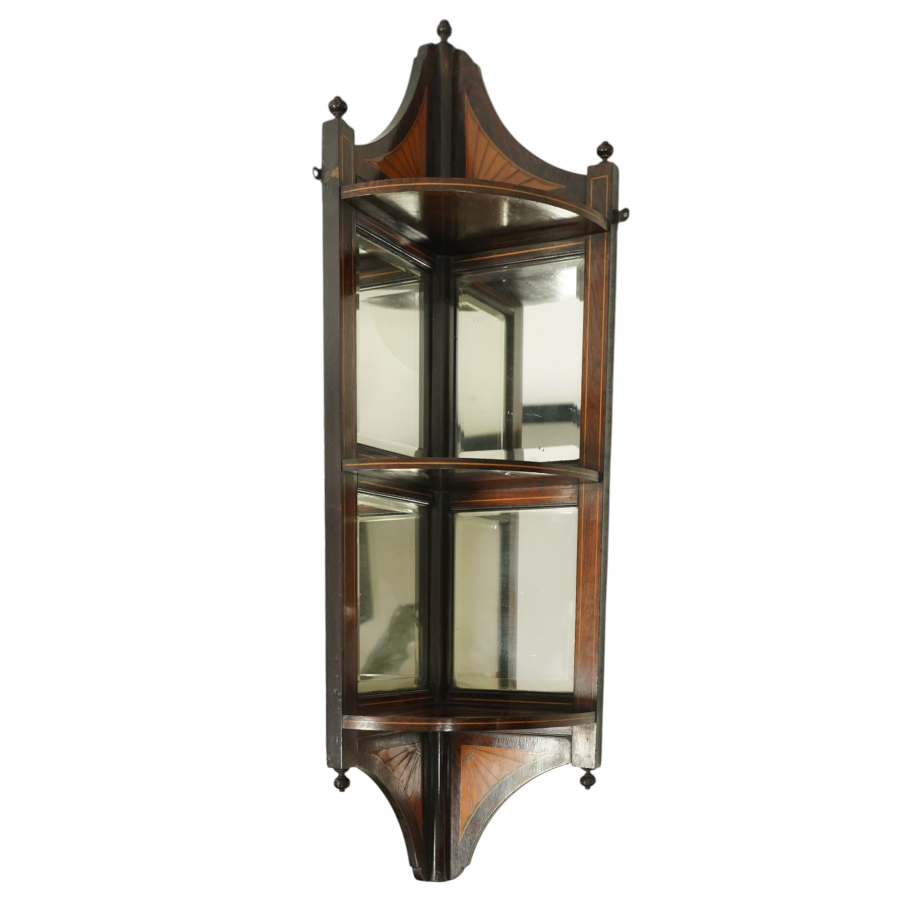 Edwardian mahogany corner two-tier shelf, with two bevelled mirrored panels on each tier, and an arched pediment with turned finals and decorative fan-shaped satinwood inlay with boxwood stringing, shaped lower apron also with satinwood fan inlay 
