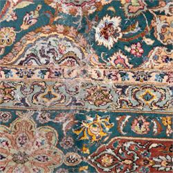 Persian Tabriz type carpet, the teal ground decorated with central medallion, radiating palmettes and dense floral scrollwork, within multiple floral borders