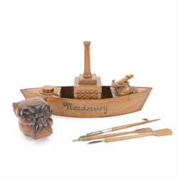 Novelty desk inkwell formed as a boat, with central chimney opening to reveal a metal inkwell with two pens formed as oars, together with another inkwell in the from of a bull dog 