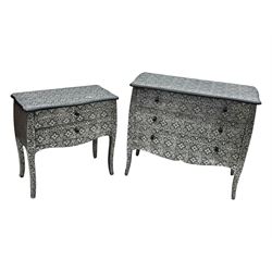 Contemporary black lacquered metal-clad chest, embossed with silver floral scrollwork, shaped rectangular top over three drawers, on cabriole supports (W89cm, D40cm, H79cm); matching two drawer chest (W68cm, D35cm, H67cm)