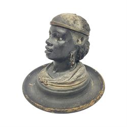 19th Century bronze figural inkwell, modelled as the head of an African-American woman with beaded hairnet and hoop earrings, her hairnet opening to reveal ink recess, the whole upon a turned circular wooden base, H14cm