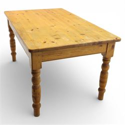 Late 20th century pine farmhouse dining table and four chairs, the rectangular plank top with rounded corners over two frieze drawers fitted with turned knob handles, raised on turned legs, the chairs with shaped ladder backs and turned finials, rush seats in a herringbone weave, on turned supports united by stretchers