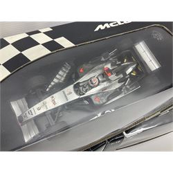 Three Minichamps 1:18 scale die-cast McLaren racing cars - Mercedes MP4-19 D. Coulthard; Mercedes MP4-20 K. Raikkonen; and Vodaphone Mercedes MP4-22 L. Hamilton 2007; all boxed (3)

