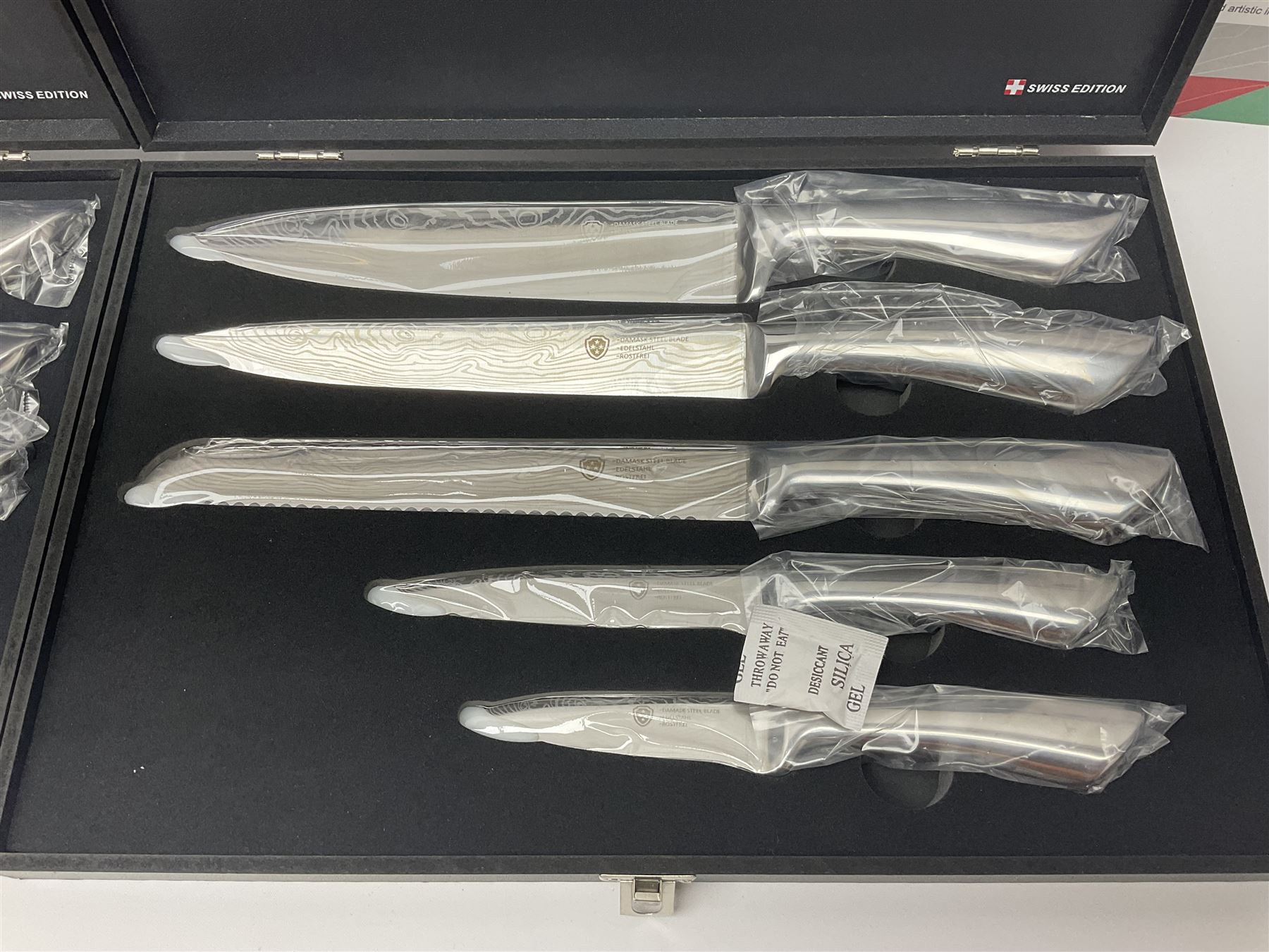 Two cased Swiss knife sets