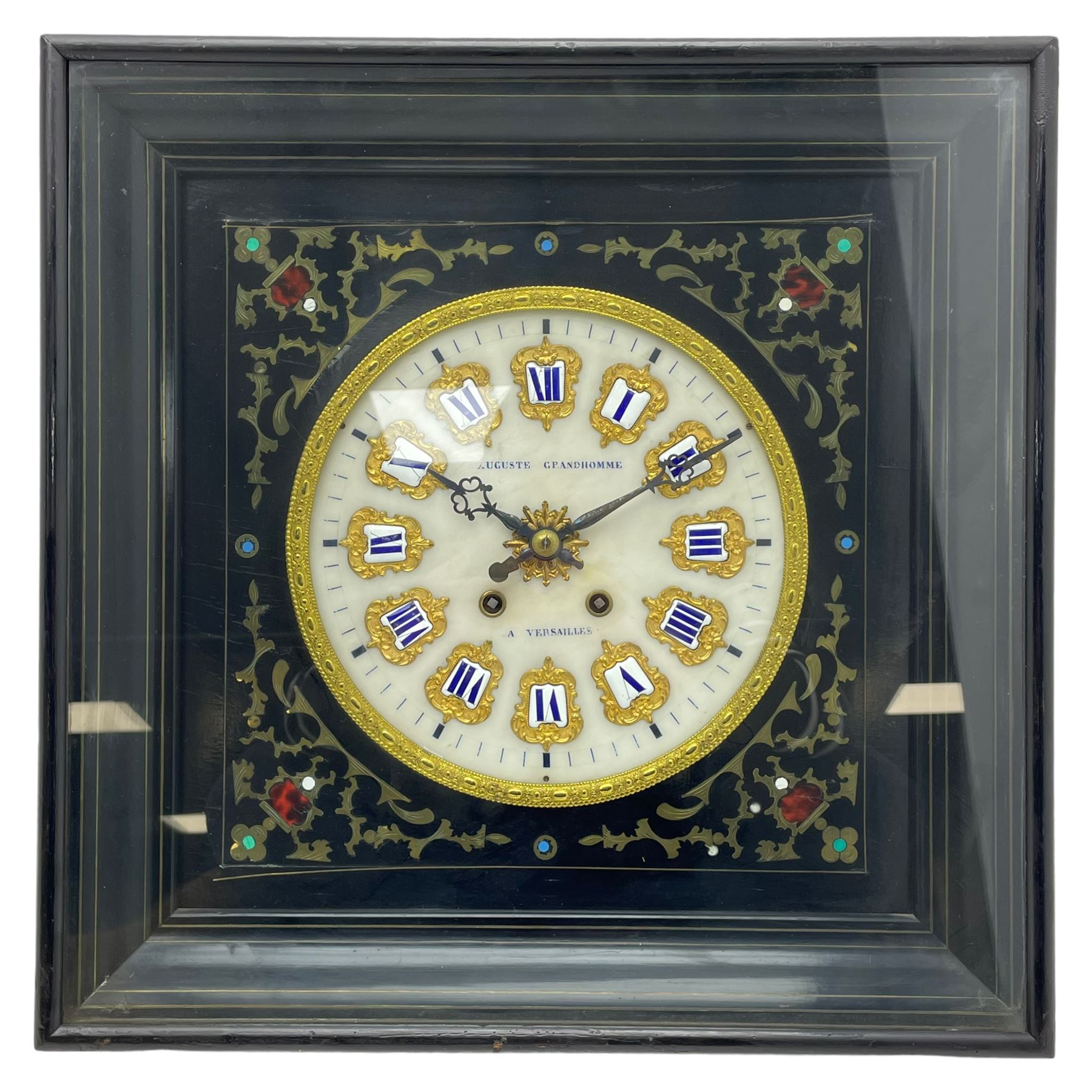 Auguste GP. Andhomme - French vineyard clock,  late 19th century 8-day twin train spring driven wall clock with enamelled and inlaid brass decoration within an ebonised and glazed case, circular enamel dial with cartouche Roman numerals, minute markers, pieced steel hands and a chased brass slip, striking movement, sounding the hours and half hours on a coiled gong. With pendulum and key.  
