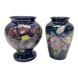 Moorcroft Clematis pattern upon cobalt blue ground miniature globular vase, together with Moorcroft Iris pattern upon a cobalt blue ground miniature vase, largest H9cm