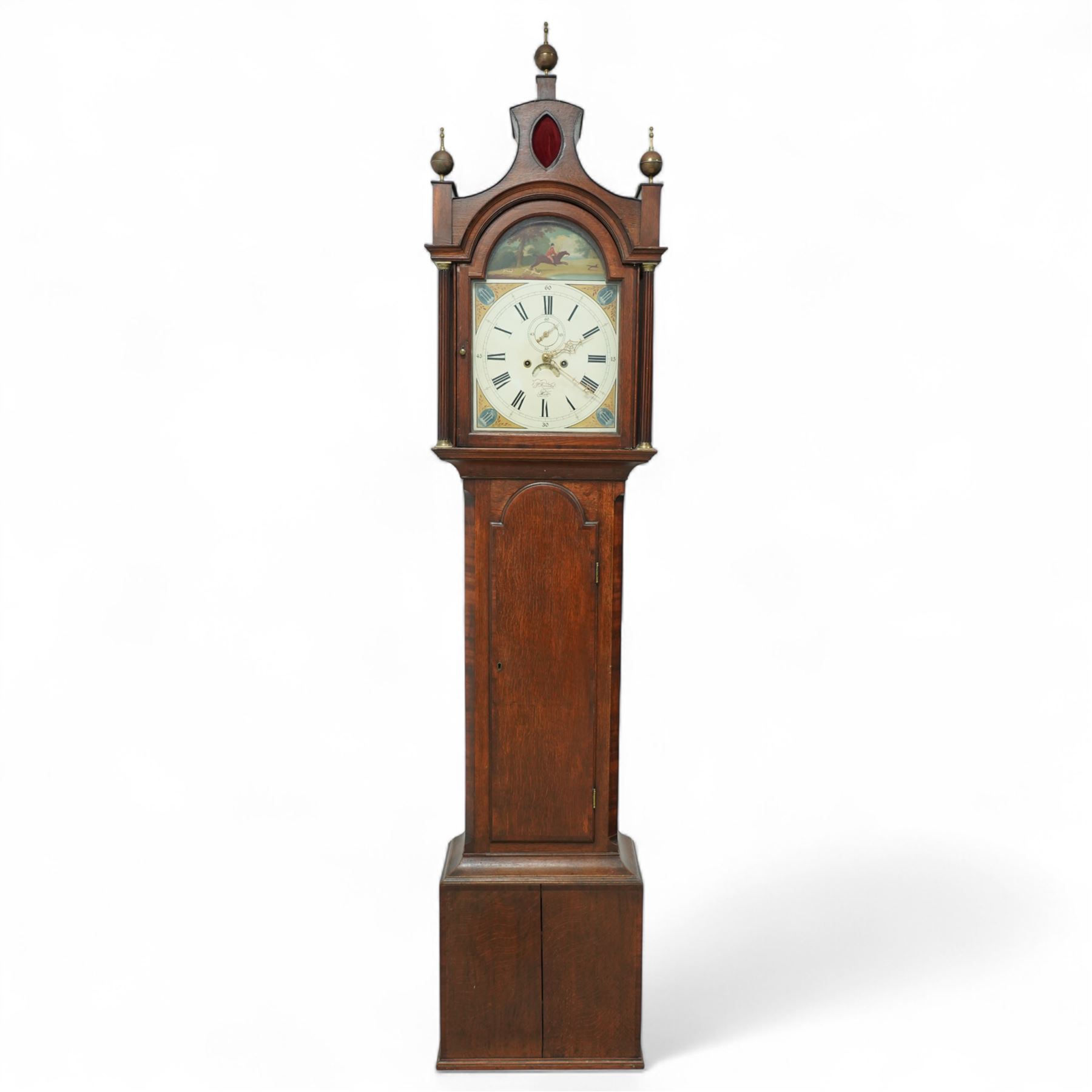 Patrick Forrester of Hull-early 19th century 8-day oak and mahogany longcase, c1830, With a pagoda pediment and three matching ball and spire finials, break arch hood door beneath flanked by reeded pilasters with brass capitals, trunk with canted corners and a full length break arch topped door with crossbanding, on a square plinth with an applied moulding to the base, fully painted dial with matching spandrels and a scene of a huntsman to the arch, with Roman numerals, fifteen minute Arabic's, stamped brass hands, seconds dial and date aperture, dial pinned via a falseplate to a rack striking movement, striking the hours on a bell. With key, weights and pendulum.   A good example of this refined design of case popular in the East Riding of Yorkshire and London, the hood is of particularly good proportions.
Patrick Forrester is listed as working in Hull 1813-1840, also as a Jeweller and Goldsmith.         