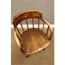  Early 20th century oak swivel office armchair, turned spindle back, on four splayed supports  