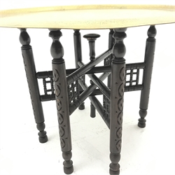Eastern Benares folding brass top table, turned carved supports, D69cm, H47cm