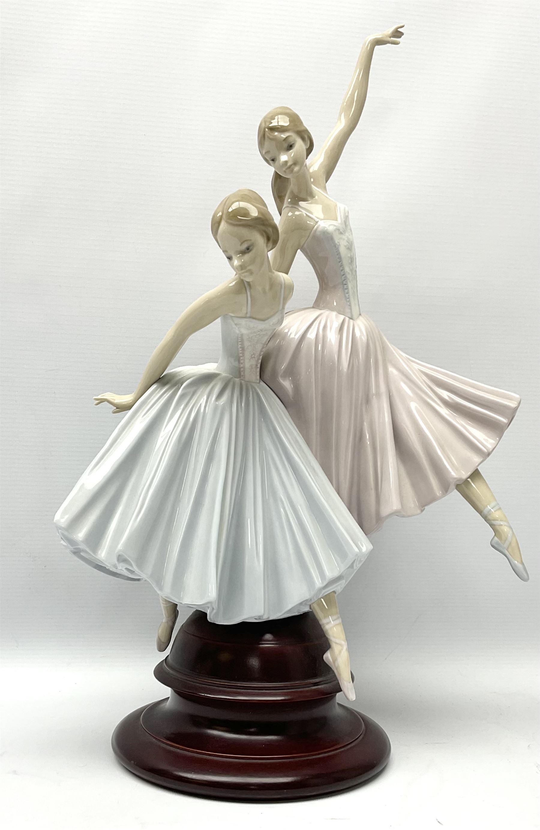 Lladro figure group, 'Merry Ballet', modelled as two ballerinas in dancing pose, raised on a turned socle base, no. 5035, printed marks beneath, H49cm