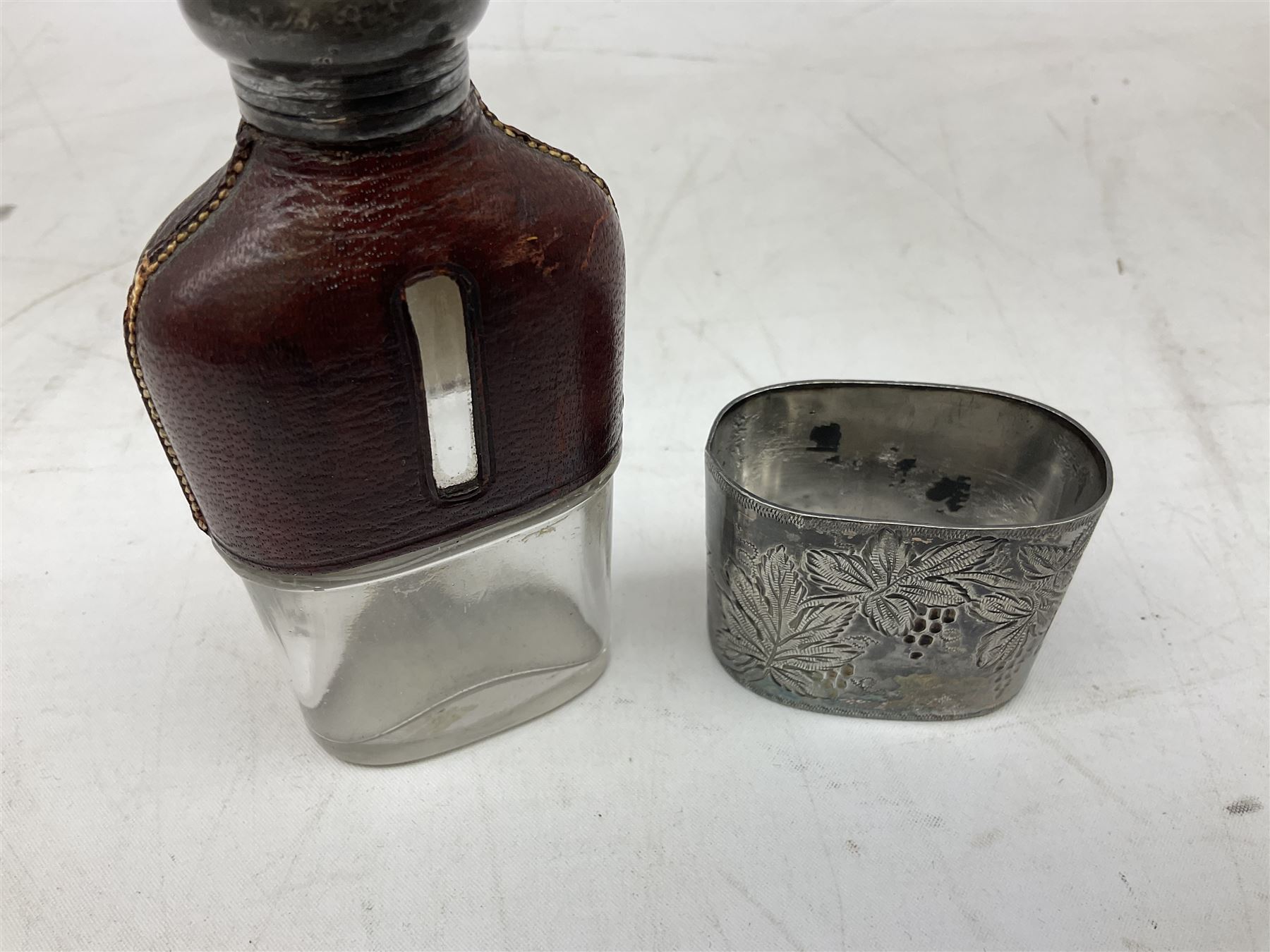 Cast metal nutcracker, in the form of a dog together with a pair of Swift Saratoga 8x40 binoculars in leather case and a hip flask, the glass flask covered in leather to the top with a detachable silver plated cup to base