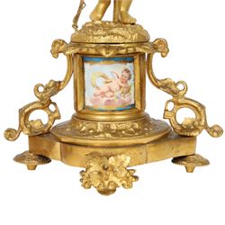 Pair of 19th century ormolu putto figures, each modelled stood with foliate support to backs, upon a naturalistic base upon cylindrical plinth each with twin leafy tendril supports, each plinth with inset Sevres type painted panel of a cherub, upon a shaped base with four compressed disk feet, the front facing with leaf mount, H29cm