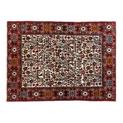 North west Persian Rudbar hand-knotted rug, ivory field woven with a repeating pattern of ...