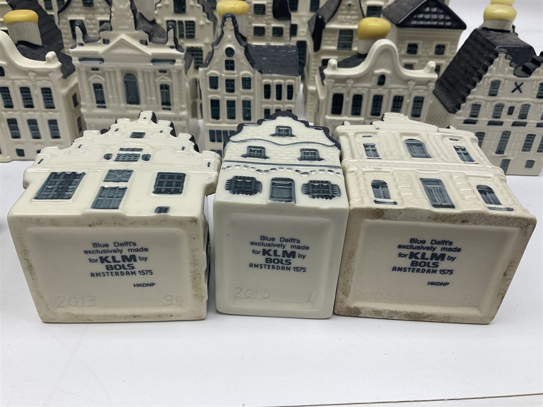 Twenty seven KLM Bols Blue Delft's decanters in the form of Dutch houses, some with contents