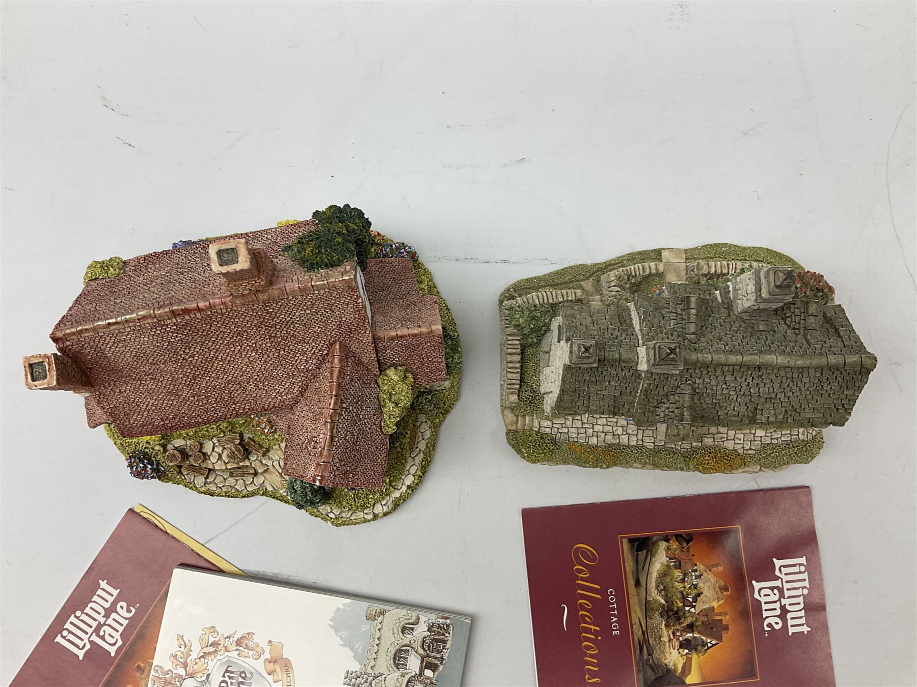 Nine Lilliput Lane cottages from the British and English collections to include Crown Inn, Wealden House, Puffin Row, etc, all boxed, one without deeds