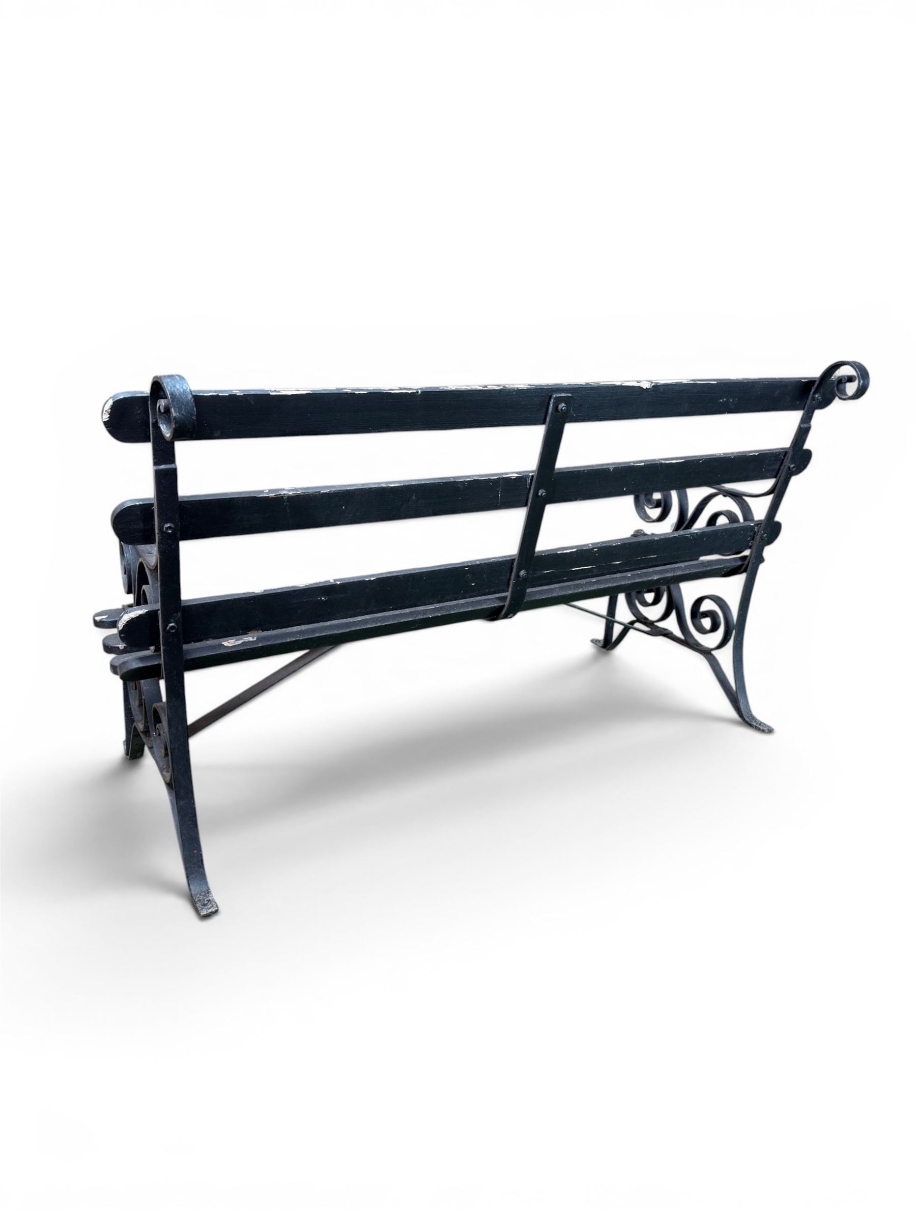 Coalbrookdale - rare pair of wrought iron and slatted wood garden benches, the twin wrought iron strapwork bench-ends formed of four scrolls over splayed feet, number 77 in the Coalbrookdale Castings Catalogue (see illustration)