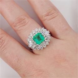 18ct white gold Colombian emerald and diamond cluster ring by Iliana, single octagonal cut emerald of 1.65 carat, surrounded by two rows of round brilliant cut and tapered baguette cut diamonds, hallmarked