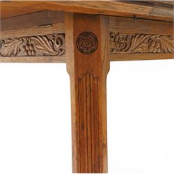 Waring & Gillow - Arts and Crafts oak draw-leaf extending dining table rectangular moulded top with chamfered corners, two additional leaves, carved frieze over fluted section supports, united by low X-shape stretchers