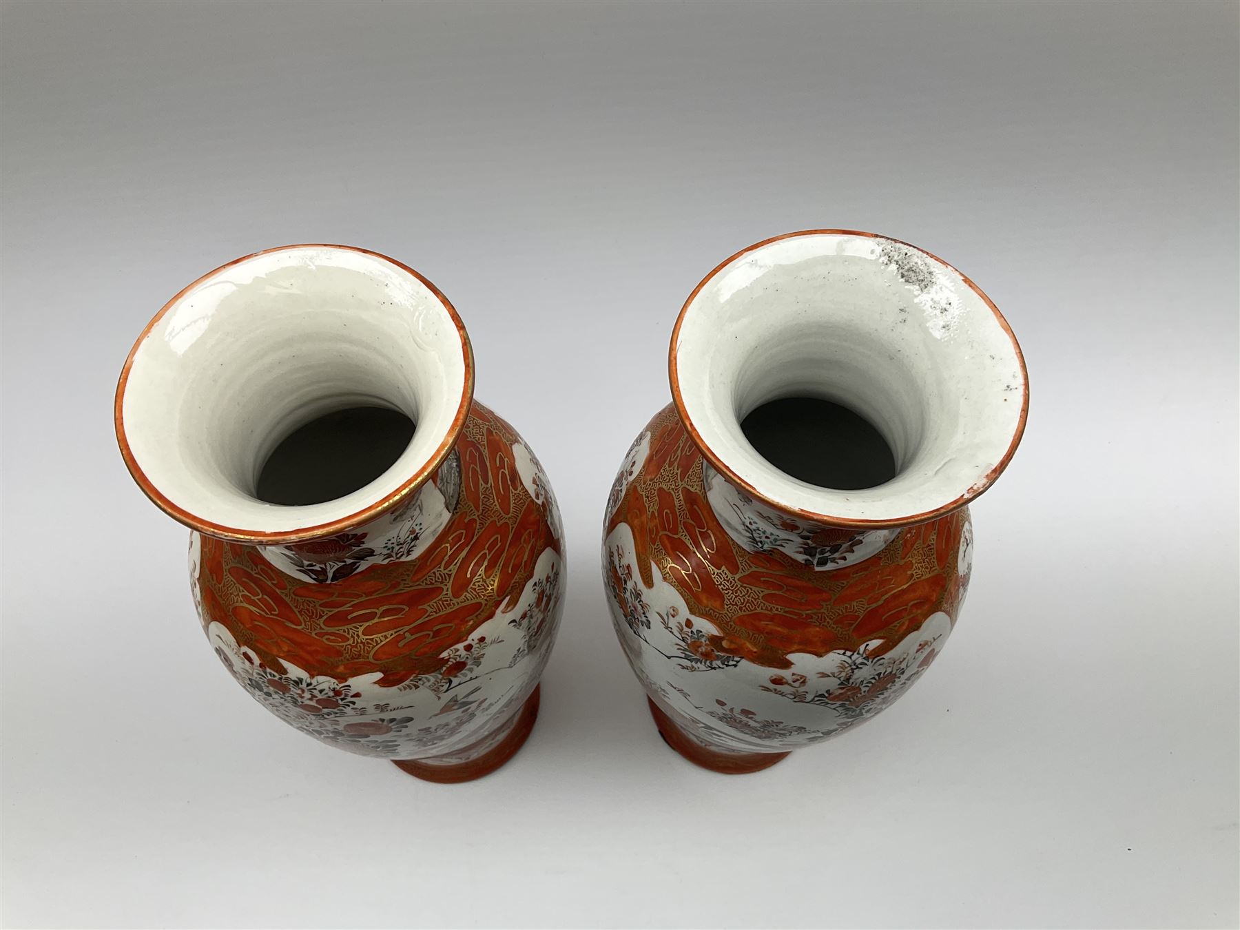 A pair of Japanese Kutani vases, of baluster form decorated with panels of birds and flowers, each with marks beneath, H30cm. 
