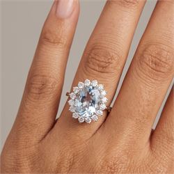 18ct white gold aquamarine and diamond cluster ring, single oval cut aquamarine of approx 2.25 carat, surrounded by sixteen round brilliant cut diamonds, stamped 18K, total diamond weight approx 0.50 carat