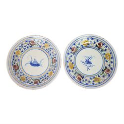 Pair of 20th century Spanish tin glazed polychrome plates, each painted with central folia...