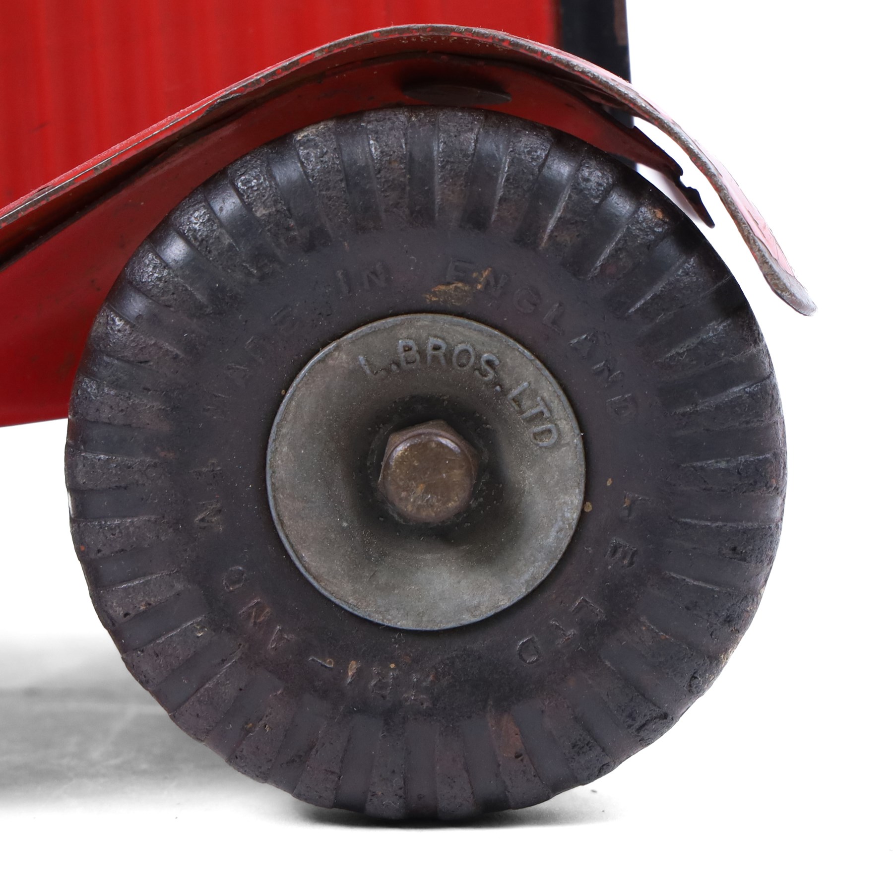Tri-ang/Line Bros Ltd tin plate tipper truck, red body with black rubber wheels and red seat and steering wheel to interior, H49cm, L16cm