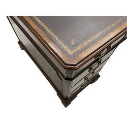 Large Georgian design mahogany twin pedestal partner's desk, moulded rectangular top with canted corners and inset leather writing surface, fitted with nine drawers and two cupboards, the pedestals with canted uprights decorated with blind fretwork, on ogee bracket feet