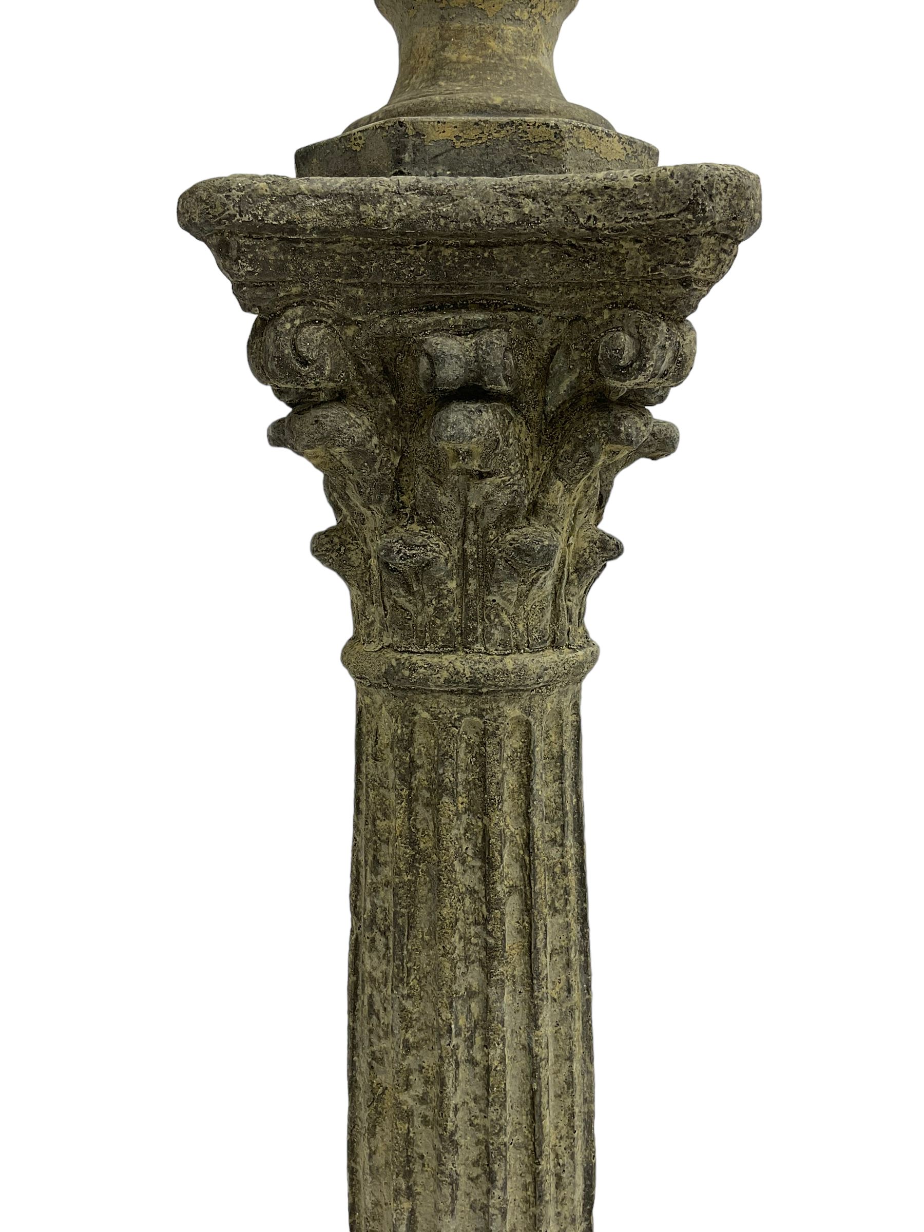 Classical design cast stone female bust depicting Artemis, raised on fluted Corinthian column with acanthus leaf capital, stepped square base, looking right 