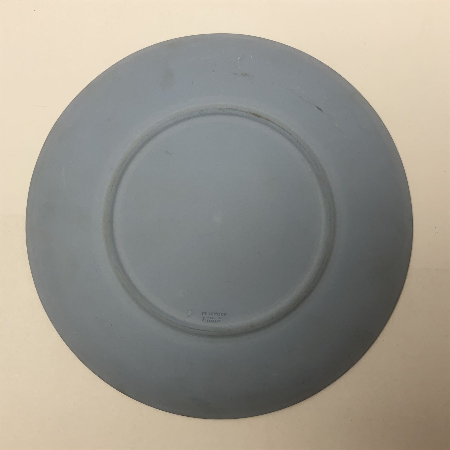 Group of William Wilberforce Abolition of Slavery items, comprising Wedgwood black on cane Jasperware pin tray, Wedgwood light blue Jasperware plate, and two Wedgwood oval medallion pendants, each depicting a kneeling figure beneath the inscription 'AM I NOT A MAN AND A BROTHER?', an Eastgate pottery plaque decorated in relief with a kneeling figure before William Wilberforce, a Hull Museum Publications pamphlet titled 'Medals, Tokens, etc., Issued in Connection with William Wilberforce and the Abolition of Slavery', by Thomas Sheppard, dated 1916, and an antique print depicting William Wilberforce after the original portrait by George Richmond, (7)