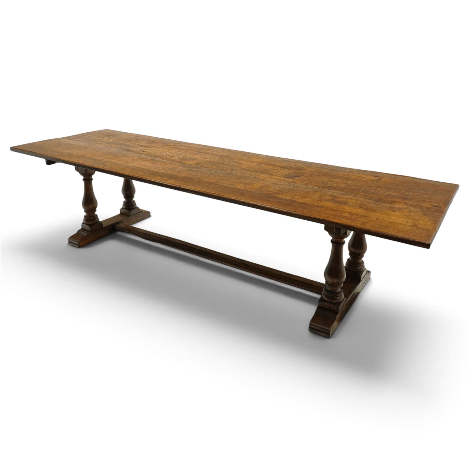 Large 17th century design oak 10ft refectory dining table, the rectangular top raised on twin double-vasiform pedestal end supports on sledge feet, united by chamfered stretcher