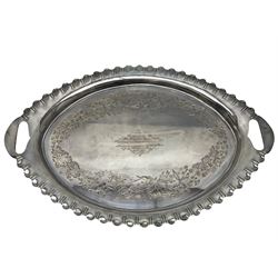 Oval silver plate twin handled tray, egg and dart edge, engraved with floral springs surrounding an central inscription, L65cm