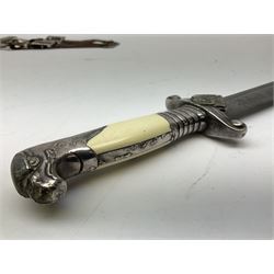 German Reichsarbeitdienst RAD Leader's Hewer dagger, the 26cm single edged scimitar shaped blade with narrow fuller, etched Arbeit adelt; by E.D. Wusthof, Solingen; the aluminium hilt with spade and wheat ear langet; two piece white plastic grip and eagle head pommel; pebbled steel scabbard engraved with ears of wheat and strapwork with double leather hangers L40cm overall