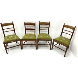 Four Regency mahogany dining chairs, shaped cresting rails, green ground tapestry seats, square tapering supports 