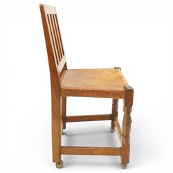 Mouseman - 1940s oak side chair, the slat-back over a slung leather seat, raised on octagonal front supports united by box stretcher, carved with slim mouse signature, by the workshop of Robert Thompson of Kilburn