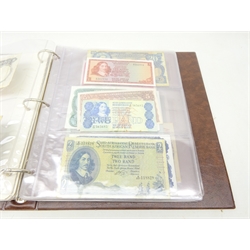  Collection of World banknotes including two 1 dollar, two 2 dollar and one 5 dollar Canadian 1954 notes, seven 1967 Canadian 1 dollar notes, six United States of America 1 dollar bills and three 5 dollar bills with various colour seals, Russia 50 rubles 1899, East African Currency Board 20 shillings, Central Bank of Malta 10 shillings 1967, early 20th Century French and German banknotes, Amsterdam 10 gulden 1953 and other world banknotes, housed in a banknote album  