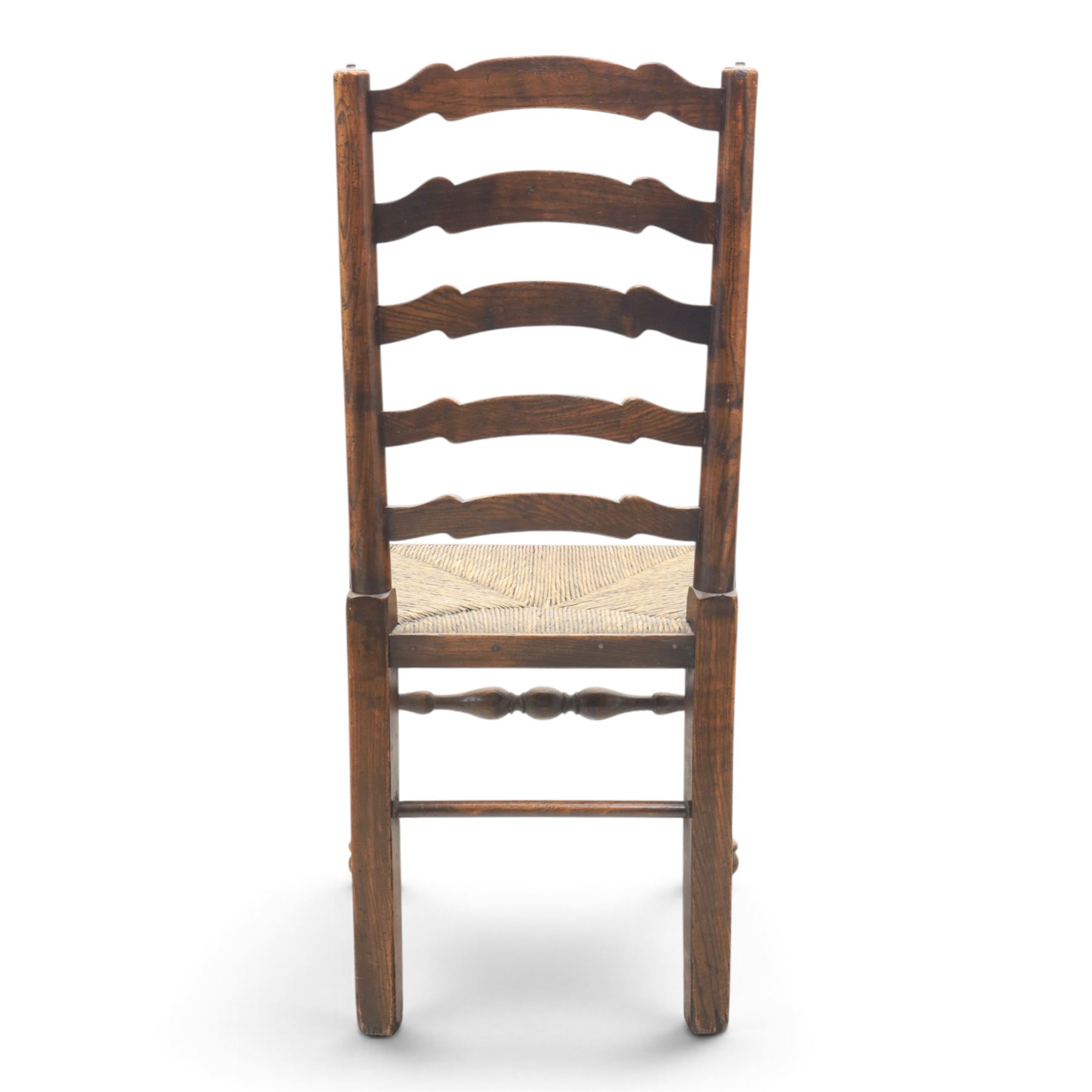 19th century set of six ash and elm ladderback dining chairs, shaped ladder backs above rush seats, raised on turned front supports with pad feet, united by turned stretchers