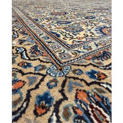 Northwestern Persian Tabriz hand-knotted carpet, the ivory ground with an all-over repeating Herati pattern of stylised palmettes, rosettes and serrated leaves in shades of indigo, terracotta and sky blue, framed by a dark blue border of arabesque vines and scrolling foliage between floral guard stripes, from the region of Tabriz