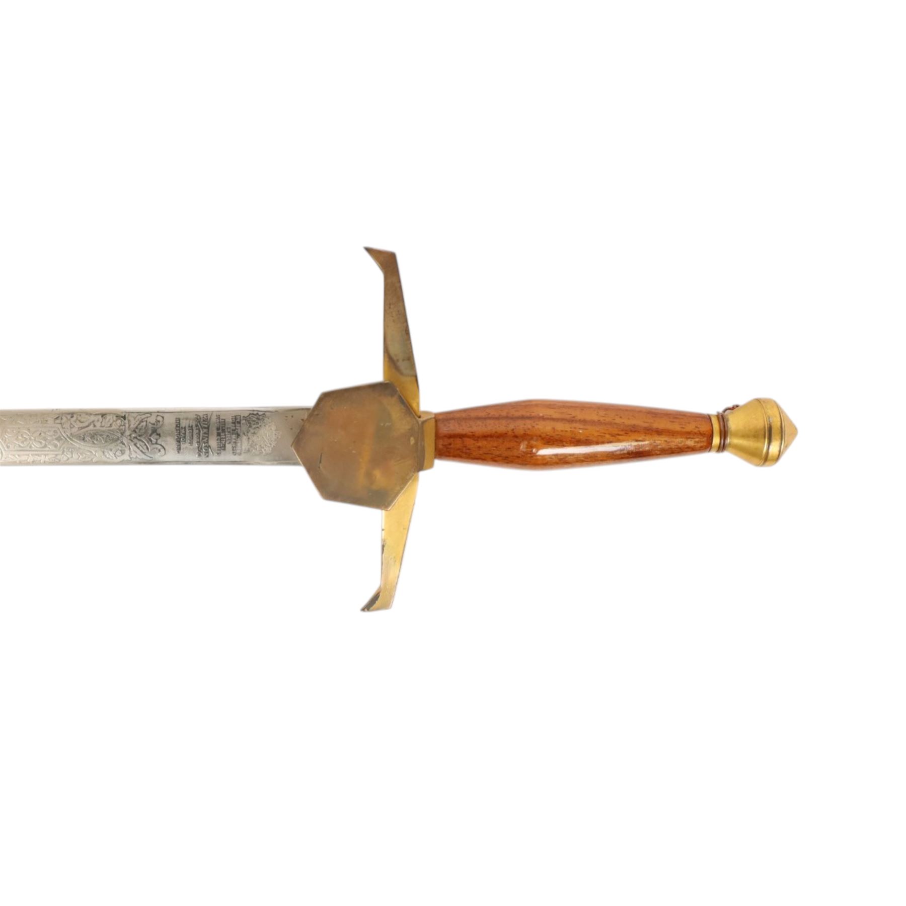 Wilkinson Sword, with 76cm double edge blade, etched with makers name and decoration, wooden grip, brass guard and hilt, together with another sword
