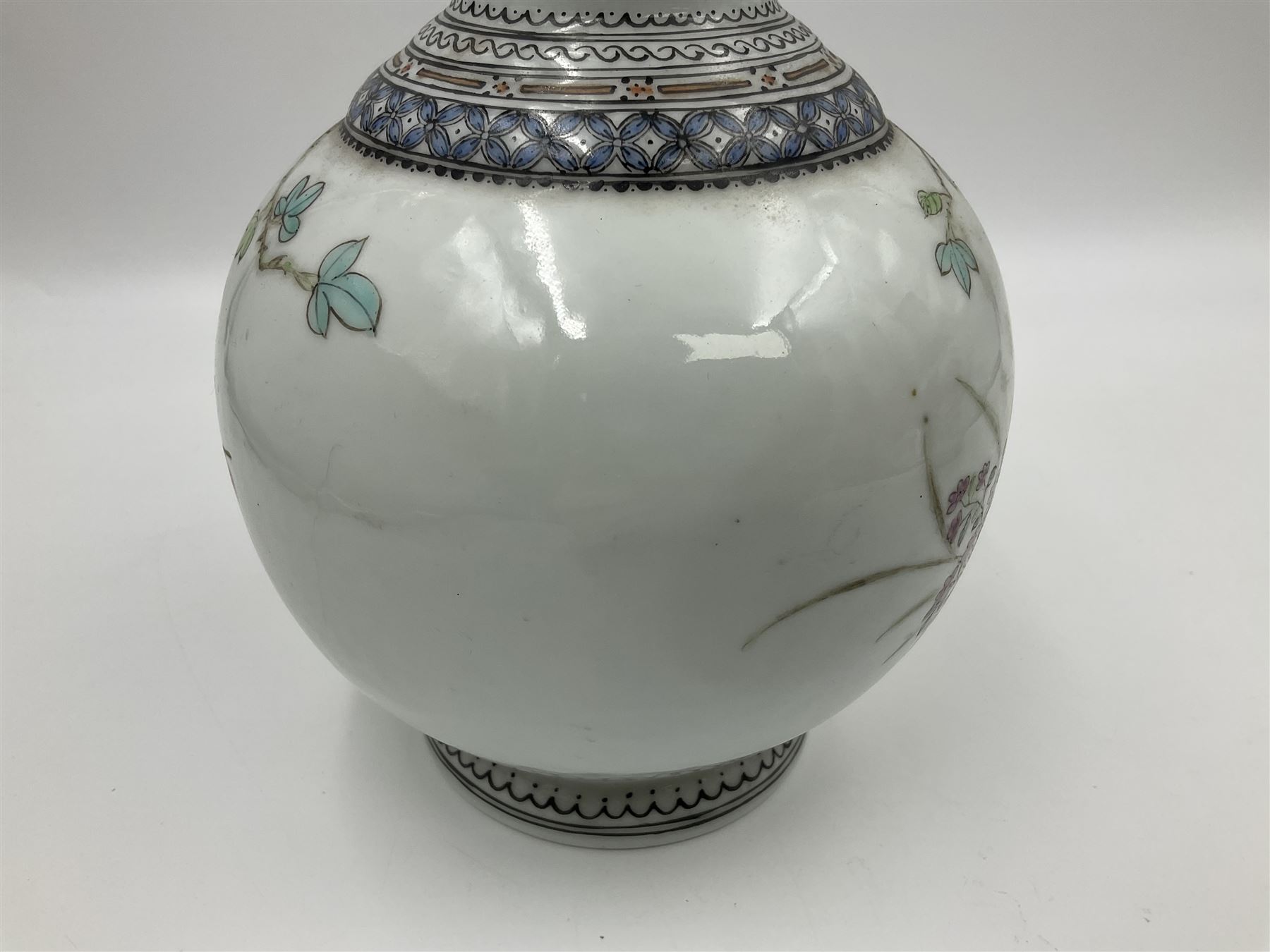 Pair of Chinese Republic porcelain vases, each painted in Famille Rose enamels with pairs of pigeons amidst peony, rock, flowering plants and leafy branches, possibly Qianlong seal beneath, H22cm 