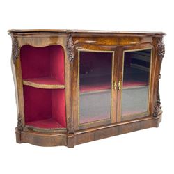 19th century rosewood buffet credenza, bombe form with shaped and moulded top, two central glazed doors with foliate moulded gilt slips, the red fabric-lined interior fitted with a single shelf, flanked by open shelves with raised gilt metal lips, the uprights decorated with shell and flower head carved cartouche mounts, acanthus leaf scroll carved lower mounts, on shaped and moulded plinth base 