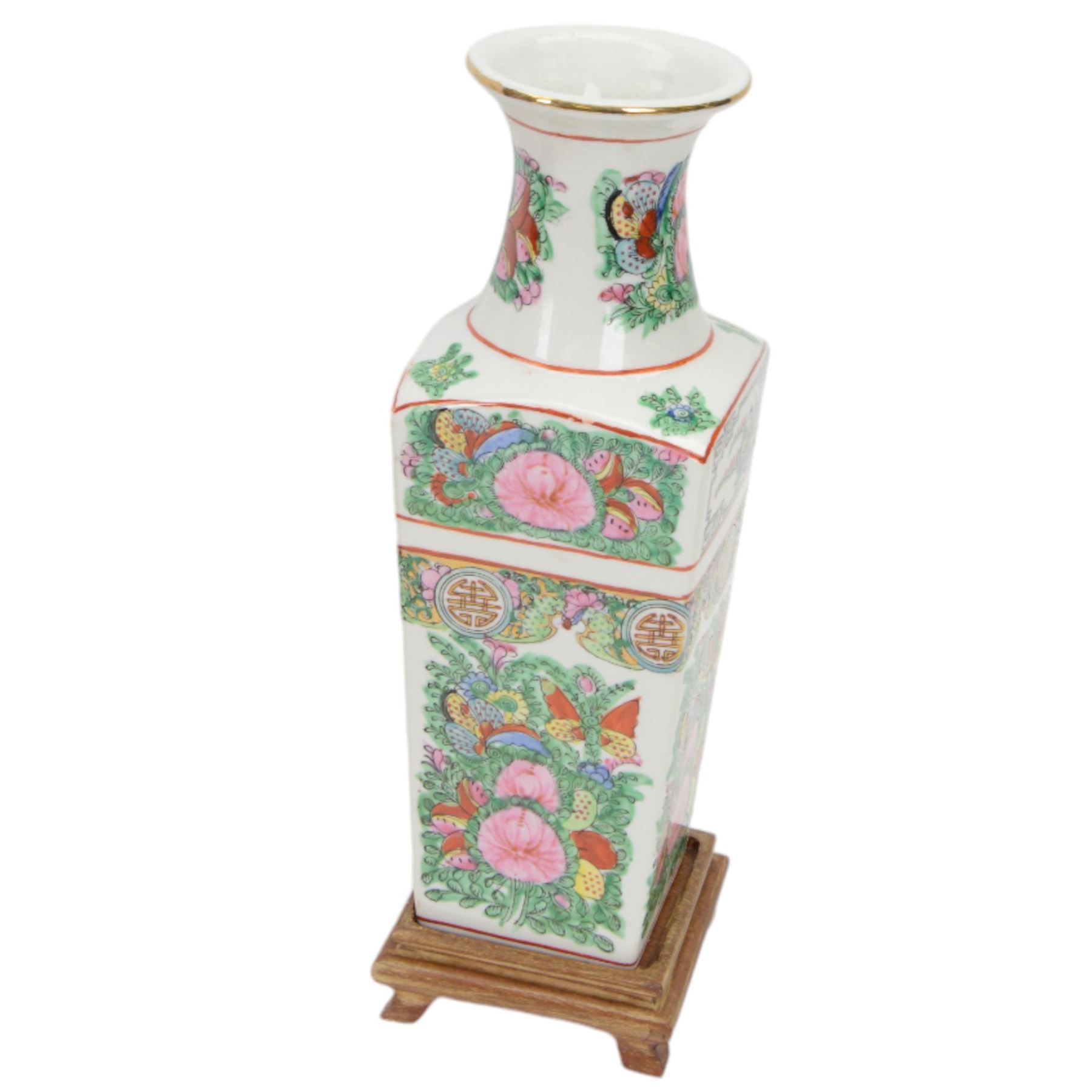 20th century Chinese sang de boeuf vase of baluster form with elephant head handles, togehter with a pair of famille rose vases decorated with floral decoration and insects, upon wooden stands   
