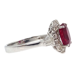  18ct white gold ruby and diamond cluster ring, with tapering baguette diamond shoulders, stamped 750, ruby approx 2.4 carat, diamonds approx 0.7 carat  