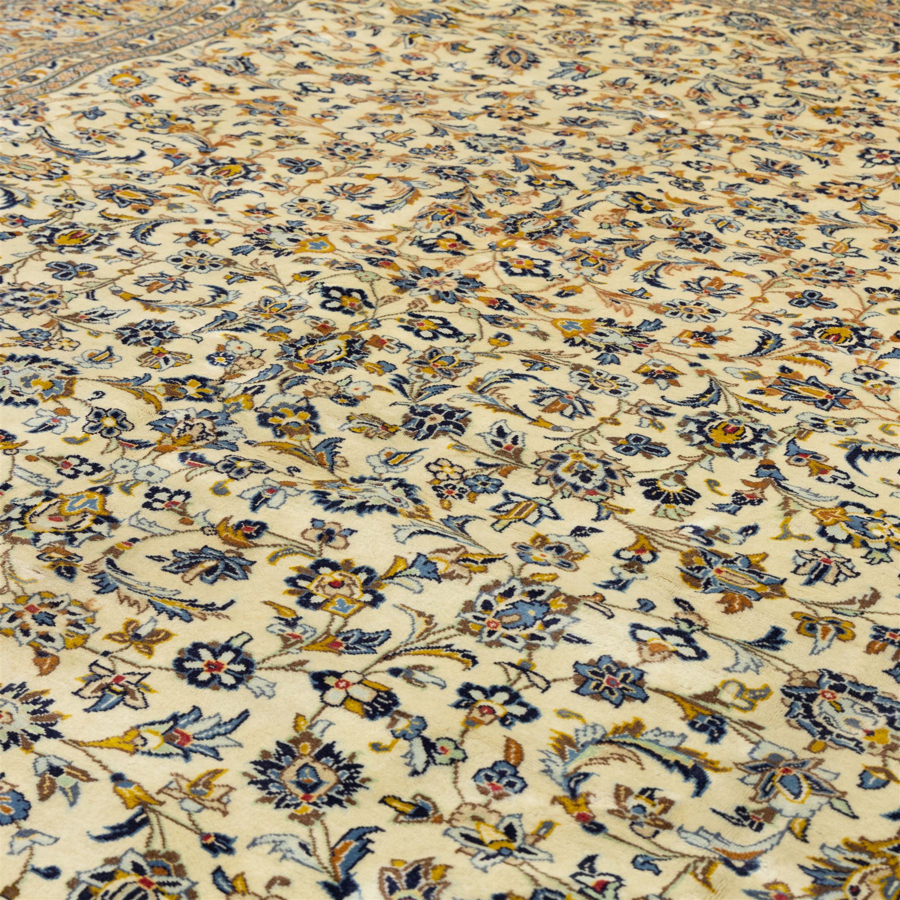 Central Persian Ardakan hand-knotted carpet, ivory field finely decorated with a symmetrical lattice of scrolling vines palmettes and flowering sprays arranged around a delicate central medallion enclosed by a pale border of stylized floral and vine ornament between multiple guard stripes with cotton fringe ends 