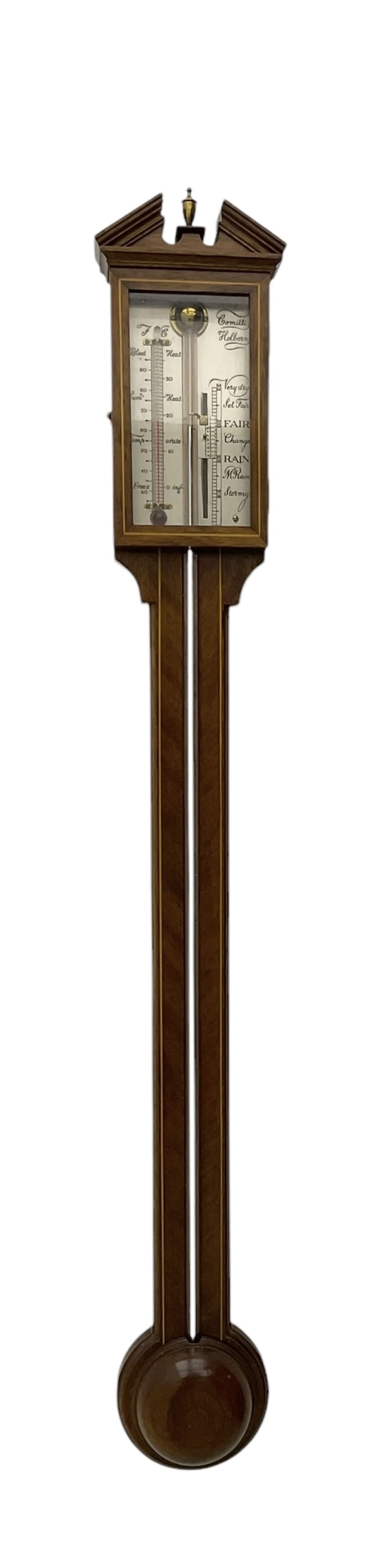 Comitti-20th century mercury stick barometer in an 18th century style mahogany case with satinwood stringing, with a broken pediment, brass finial and round base, silvered register with recording vernier, weather predictions and a centigrade/Fahrenheit spirit thermometer enclosed within a glazed door, visible tube with a bulb cistern and turned mahogany cover.
Mercury clean and present with no air locks.