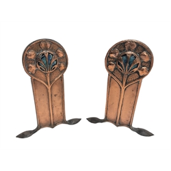  Pair Art Nouveau period beaten and embossed copper fire dogs, stylized flower head motif set with Ruskin style cabochons, wrought iron supports, H30cm x W24cm  