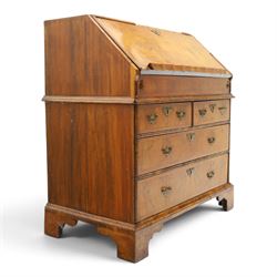 18th century figured walnut bureau, the sloped fall-front enclosing fitted interior with sliding base, pigeon-holes and correspondence drawers with shaped facias, over two short and two long feather-banded drawers with pressed brass handle plates, on bracket feet