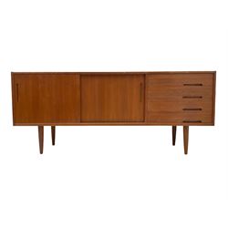 Nils Jonsson - mid-20th century teak sideboard, rectangular top over three-section base, left and centre sections with sliding double doors enclosing shelving, right section with four drawers, raised on tapered supports