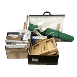 Collection of art supplies and equipment, including two wooden easels, watercolor pencils, paints, reference books etc, in two boxes 