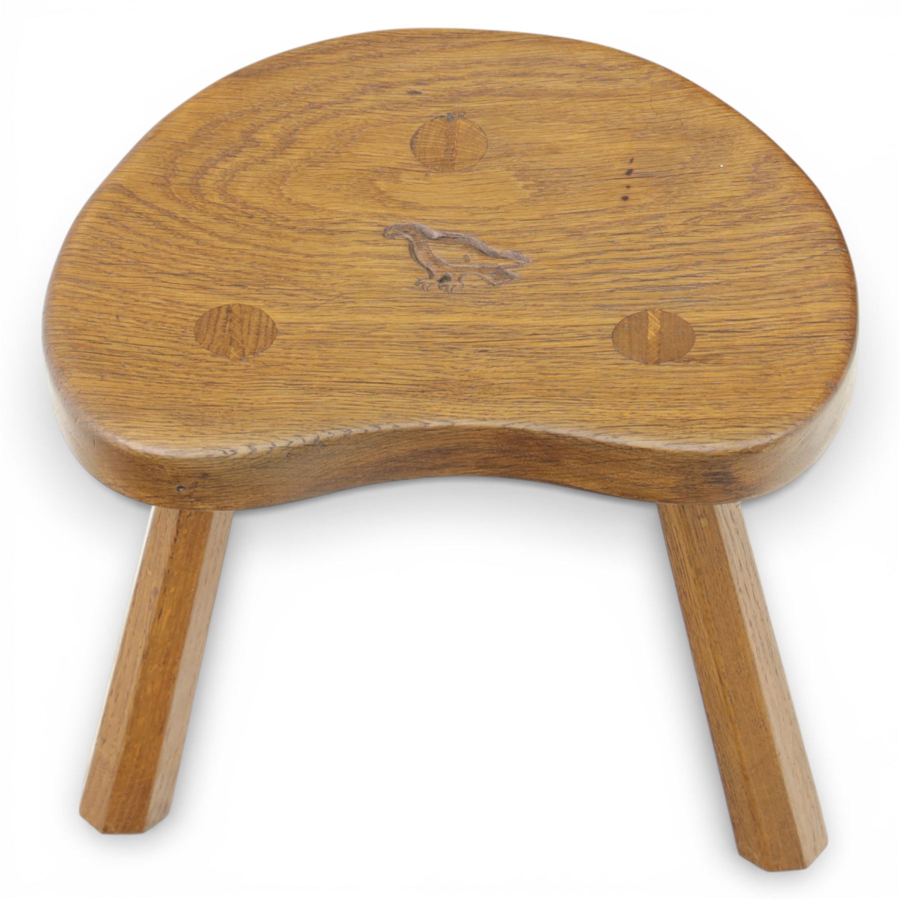 Eagleman - small oak calf stool, raised on three octagonal supports with signature Eagle motif to the seat from the workshop of Albert Jeffray, Sessay